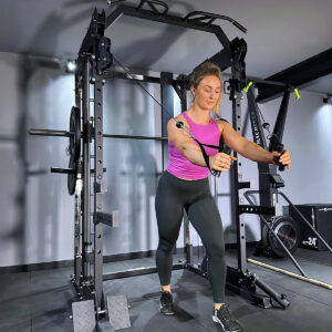 Woman doing cable rows on home gym squat rack