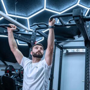 Man with Jammer Arms Pair Exercising on Power Rack